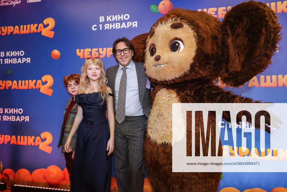 RUSSIA, MOSCOW - DECEMBER 24, 2025: Actors Ilya Kondratenko, Yeva Smirnova and TV host Andrei Malakhov (L-R) pose with an artist dressed as the title character on the red carpet during the premiere of the family comedy Cheburashka 2 by Dmitry Dyachenko at the KARO 11 Oktyabr cinema on Novy Arbat Street (New Arbat Avenue). Valery Sharifulin TASS 86692116