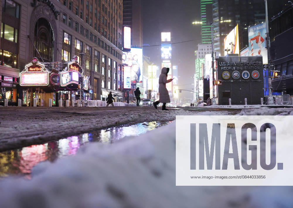 Pedestrians cross Seventh Avenue near Times Square as snow falls in the early morning on Saturday, December 27, 2025 in New York City. A winter storm warning was issued for the entire metro area, from southern Connecticut to northeast New Jersey and southeast New York. NYP20251227104 JOHNxANGELILLO