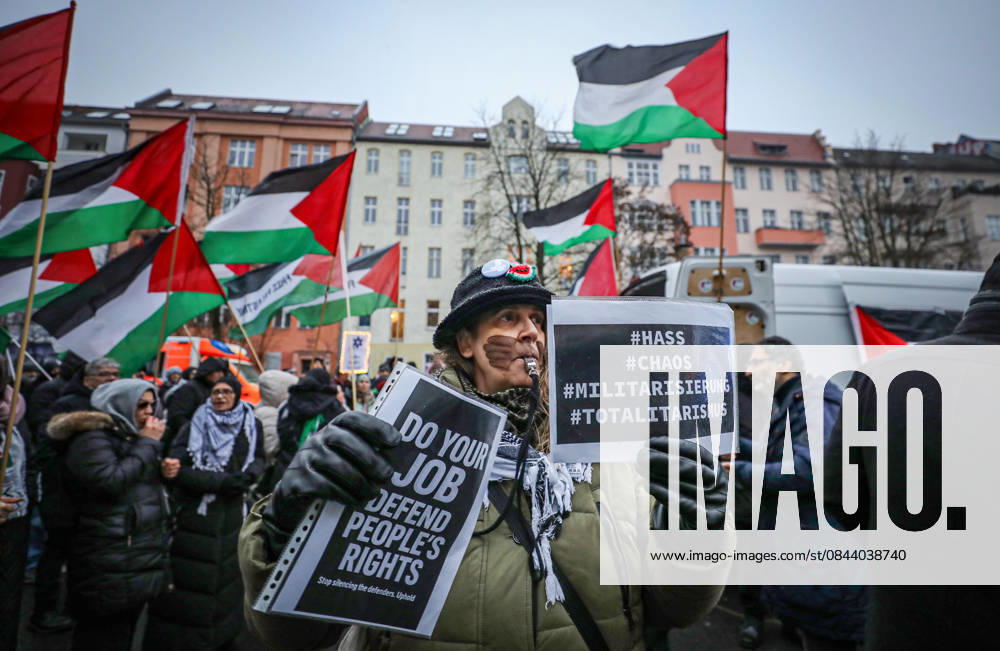 A demonstrator holds signs during a pro-Palestinian rally in Berlin, Germany, as protesters wave Palestinian flags and march through the city streets in solidarity with Palestine. Berlin Germany - ZUMAa268 20251227_zip_a268_017
