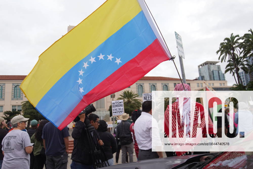 A protester holds a flag of Venezuela during the rally outside the San Diego County Administration Center. Protesters gathered outside the San Diego County Administration Center and marched through downtown San Diego voicing anger after the United States launched military strikes on Venezuela and captured President Nicolas Maduro and his wife, an operation confirmed by U.S. officials that removed them from Venezuelan territory and brought them to the United States to face charges. The action described by the U.S. government as a military operation against alleged drug-trafficking and terrorism, and by critics as an unlawful bombing and abduction has sparked widespread demonstration - ZUMAs197 20260103_aaa_s197_362