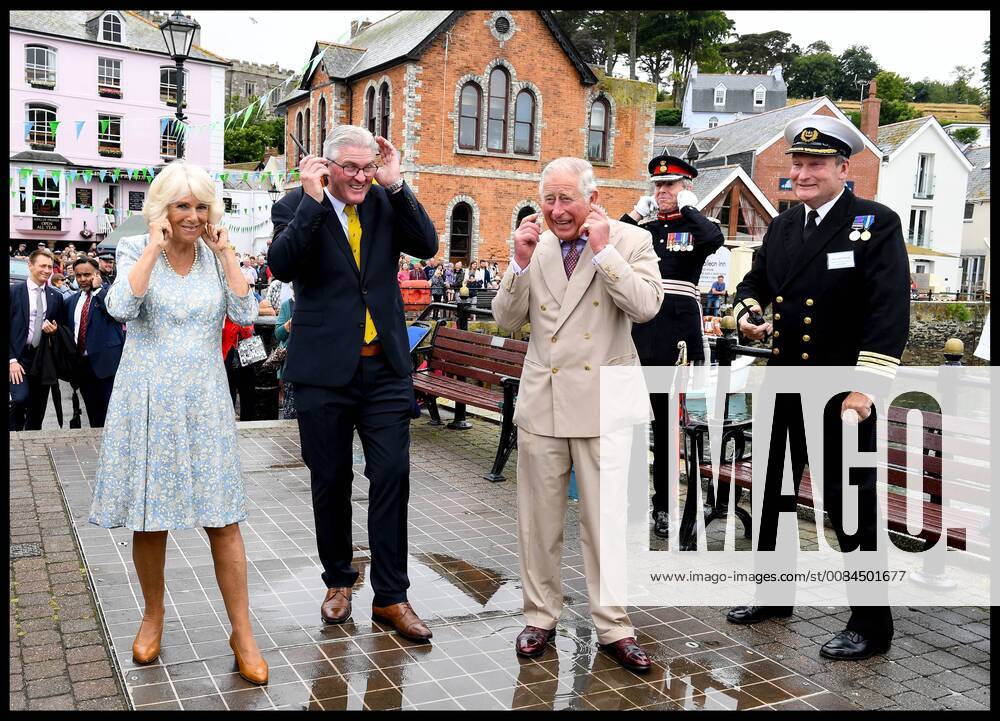 . 16 07 2018. Fowey, United Kingdom. Prince Charles the Duchess of Cornwall visit Cornwall. The Duke and Duchess of Cornwall put their fingers in their ears as the cannon gun is fired to launch the gig race as they visit the celebration of Fowey festival meeting local businesses, representatives from Fowey gig club and members of the RNLI on Fowey Quay. xAndrewxParsonsx xi-Imagesx IIM-18220-0017