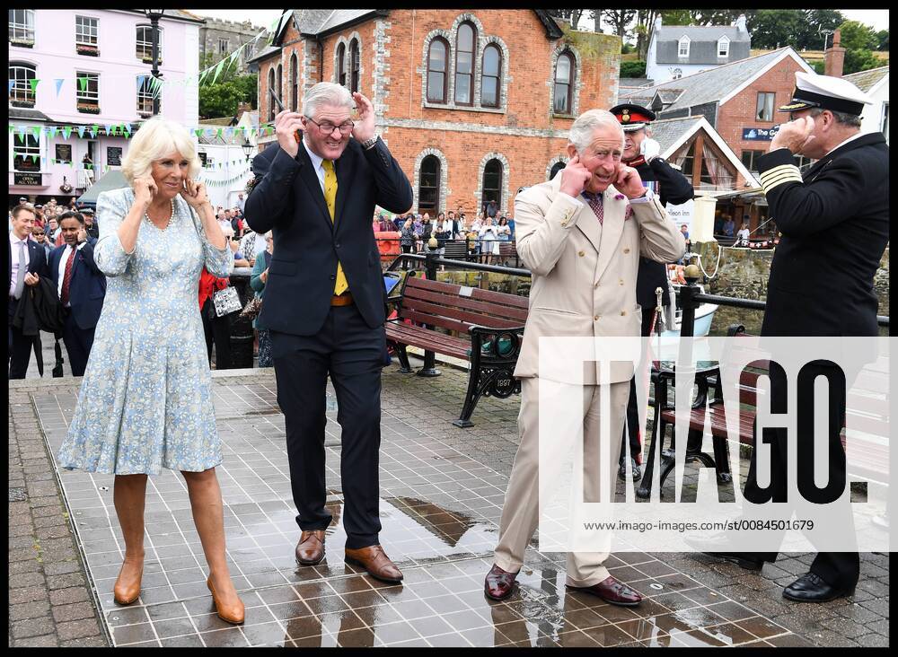 . 16 07 2018. Fowey, United Kingdom. Prince Charles the Duchess of Cornwall visit Cornwall. The Duke and Duchess of Cornwall put their fingers in their ears as the cannon gun is fired to launch the gig race as they visit the celebration of Fowey festival meeting local businesses, representatives from Fowey gig club and members of the RNLI on Fowey Quay. xAndrewxParsonsx xi-Imagesx IIM-18220-0019