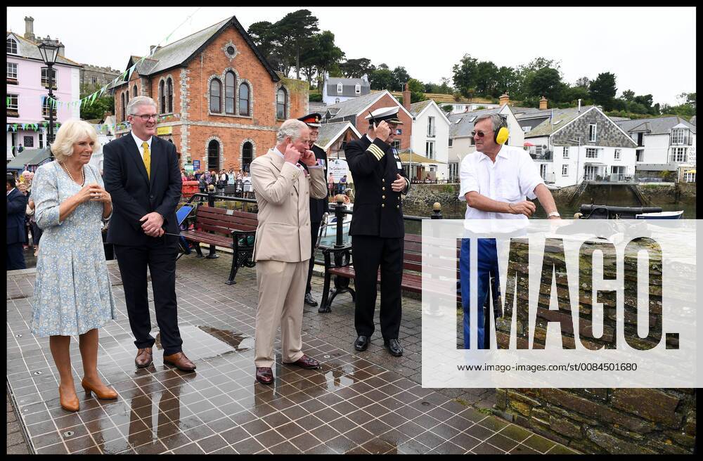 . 16 07 2018. Fowey, United Kingdom. Prince Charles the Duchess of Cornwall visit Cornwall. The Duke and Duchess of Cornwall put their fingers in their ears as the cannon gun is fired to launch the gig race as they visit the celebration of Fowey festival meeting local businesses, representatives from Fowey gig club and members of the RNLI on Fowey Quay. xAndrewxParsonsx xi-Imagesx IIM-18220-0020