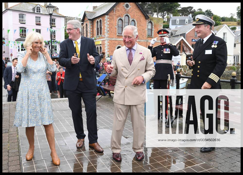 . 16 07 2018. Fowey, United Kingdom. Prince Charles the Duchess of Cornwall visit Cornwall. The Duke and Duchess of Cornwall put their fingers in their ears as the cannon gun is fired to launch the gig race as they visit the celebration of Fowey festival meeting local businesses, representatives from Fowey gig club and members of the RNLI on Fowey Quay. xAndrewxParsonsx xi-Imagesx IIM-18220-0056