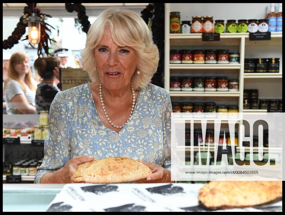 . 16 07 2018. Fowey, United Kingdom. Prince Charles the Duchess of Cornwall visit Cornwall. The Duke and Duchess of Cornwall with a cornish pasty visit the celebration of Fowey festival meeting local businesses, representatives from Fowey gig club and members of the RNLI on Fowey Quay. xAndrewxParsonsx xi-Imagesx IIM-18220-0066
