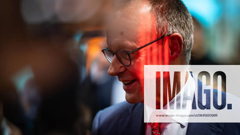 Federal Chancellor Friedrich Merz with a red light reflection on his face during the election campaign event Baden Württemberg in the election year 2026, Federal Chancellor and CDU top candidate visiting Pfenning Logistics in Heddesheim, Heddesheim Baden Württemberg Germany Company premises Pfenning Logistic