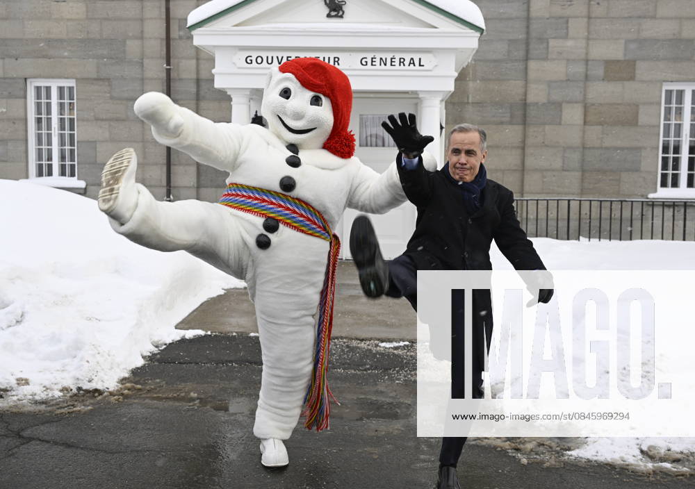 Prime Minister Mark Carney, right, and Bonhomme Carnaval raise their legs together in a traditional carnival kick, at the beginning of a Cabinet planning forum at the Citadelle in Quebec City, Thursday, Jan. 22, 2026. Quebec Canada - ZUMAc35_ 20260122_zaf_c35_018