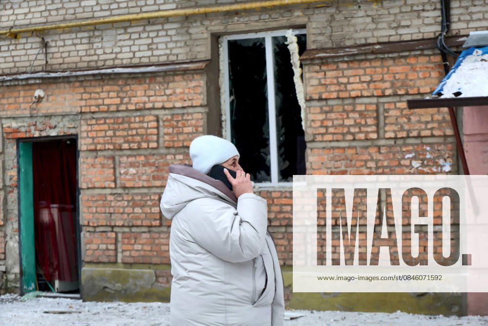 A woman talks on the phone outside an apartment block damaged by a Russian drone strike, Kharkiv, Ukraine, January 24, 2026. The overnight Russian attack left 27 people injured. Residential buildings, a maternity hospital, and a dormitory were also damaged. (Photo by Viacheslav Madiievskyi Ukrinform) Massive Russian drone attack on Kharkiv