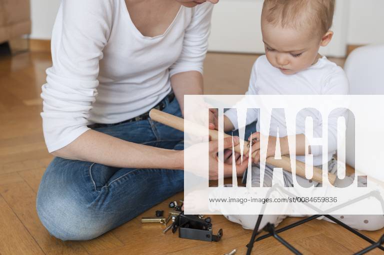 Mother and daughter assembling a chair at home model released Symbolfoto property released DIGF04585