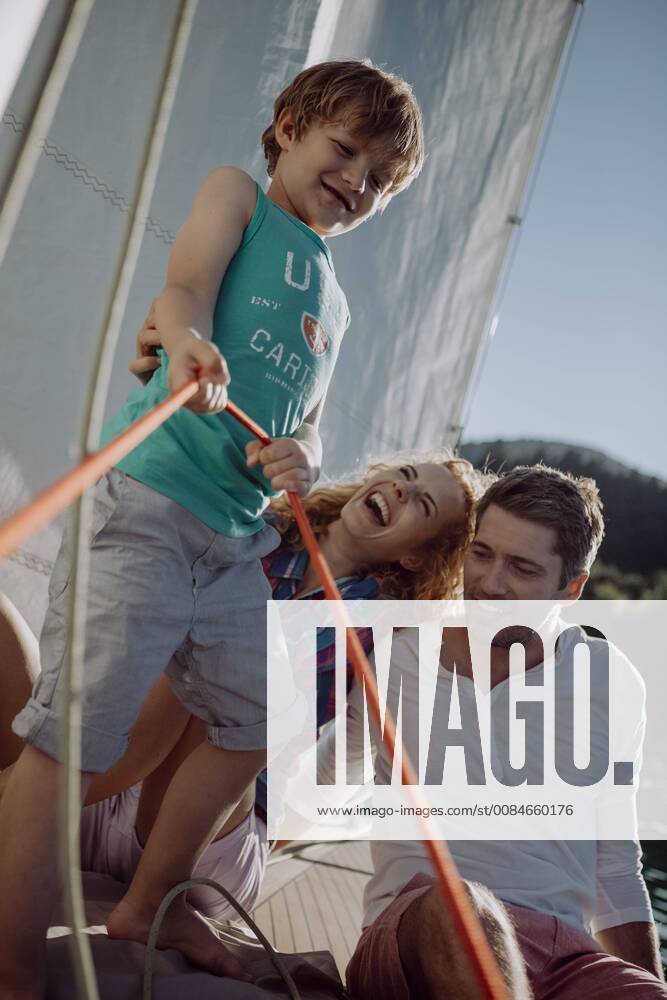 Happy family on a sailing boat model released Symbolfoto JLOF00009