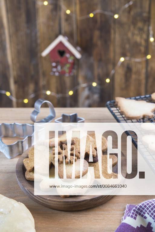 Various home-baked gingerbread cookies on wooden plate SKCF00477