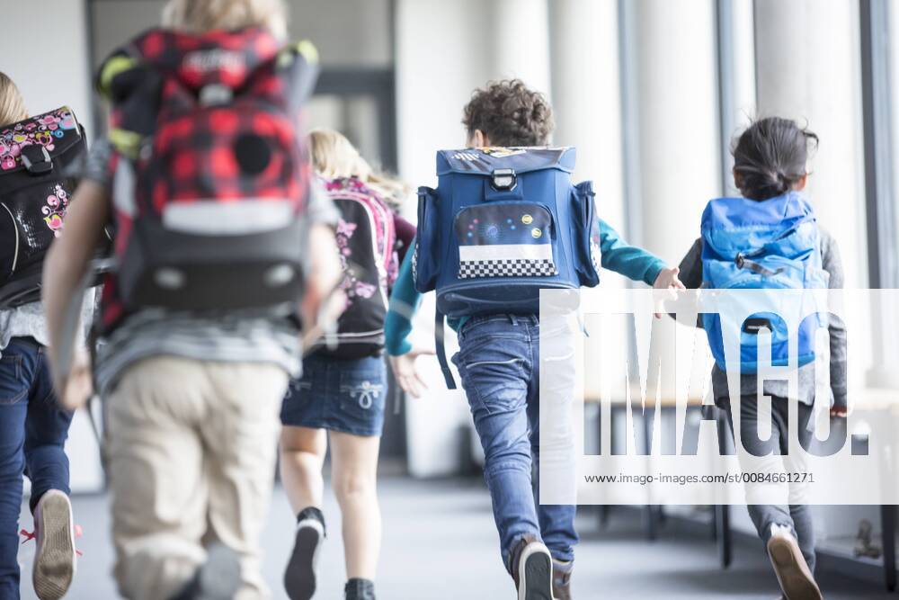 Rear view of pupils rushing down school corridor model released Symbolfoto property released WESTF24187