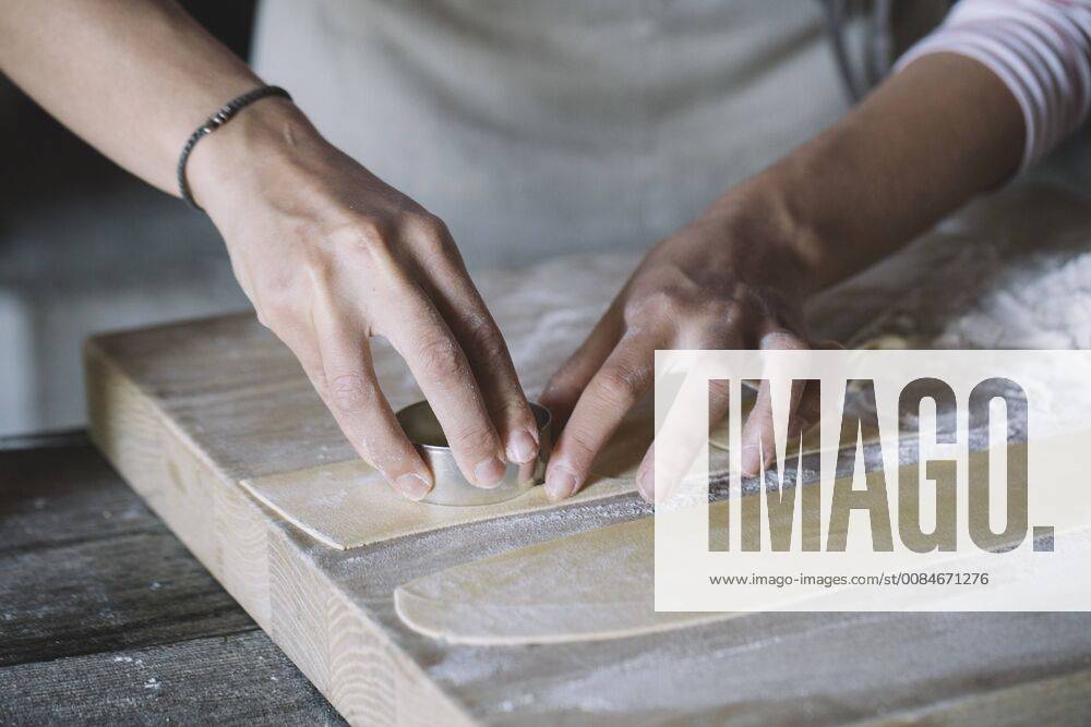 Woman preparing ravioli, pasta dough cutting out on pastry board model released Symbolfoto ALBF00500