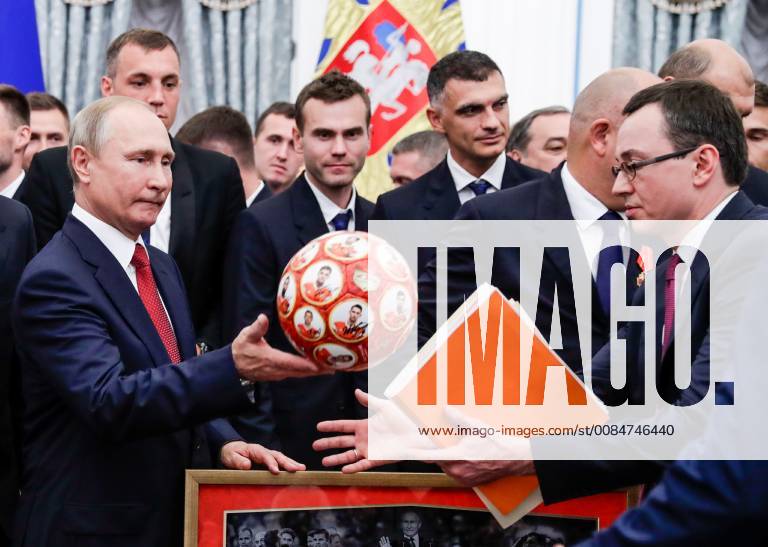 The President of Russia Vladimir Putin (front), goalkeepers Igor Akinfeyev and Vladimir Gabulov, and the Head of Russia s Presidential Protocol Office Vladislav Kitayev (L-R front) with a ball featuring images of Russian football players after a ceremony to present government awards to Russia s national men s football team and coaches at the Kremlin; the Russian national team reached the quarterfinals at the 2018 FIFA World Cup. Mikhail Metzel TASS TS08B0B0