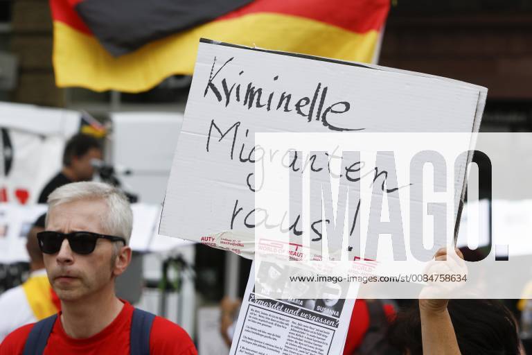 Germany: Right-wing protest held in Wiesbaden A right wing protester holds up a sign that reads Criminal migrants out! . Right-wing protesters of the Hand in Hand - Gegen die Gewalt auf unseren Strasen (Hand in Hand - against violence on our streets) movement held an anti-government rally in Wiesbaden. This protest was held under the pretext of a vigil for the teenager Susanna F, who was allegedly killed by a refugee in Wiesbaden. The rally was addressed by several anti-government speakers, who called for the government to resign. MANDATORY CREDIT: Michael Debets Wiesbaden Hesse Germany MichaelxDebets