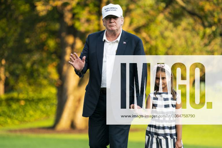 U.S. President Donald J. Trump (L) and his granddaughter Arabella Rose Kushner (R) walk across the South Lawn as they return from a weekend stay in Bedminster, New Jersey at the White House in Washington, DC, on July 29, 2018. Earlier in the day, the President once again went after the media on Twitter, calling them the enemy of the people. WAX20180729208 JIMxLOxSCALZO