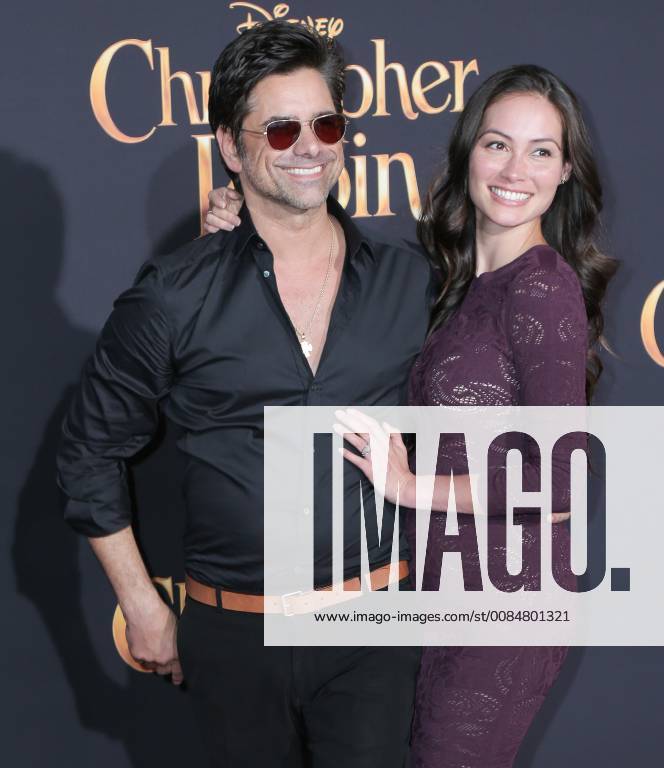 U.S. - 30 July 2018 - Burbank, California - John Stamos, Caitlin McHugh. Premiere of Disney s Christopher Robin held at Walt Disney Studios. Photo Credit: PMA AdMedia U.S. - ZUMAa123 20180730_zaa_a123_225