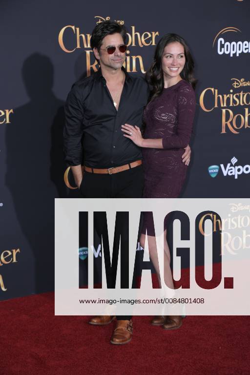U.S. - 30 July 2018 - Burbank, California - John Stamos, Caitlin McHugh. Premiere of Disney s Christopher Robin held at Walt Disney Studios. Photo Credit: PMA AdMedia U.S. - ZUMAa123 20180730_zaa_a123_252