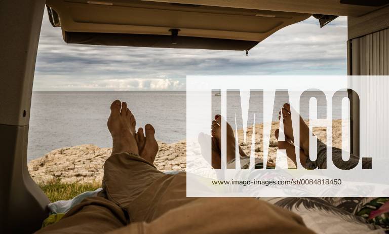 Pula THEME PICTURE Feet of a woman of a teenager and a man in a bed of a camper with an open tailgate with the panorama of the Adriatic taken on 28 June 2018 in Pula Croatia Feet of a woman with a teenage boy and a man in a bed with a open tailgate the panorama of the Adriatic Pula Croatia on 2018 06 28 EX_FEI