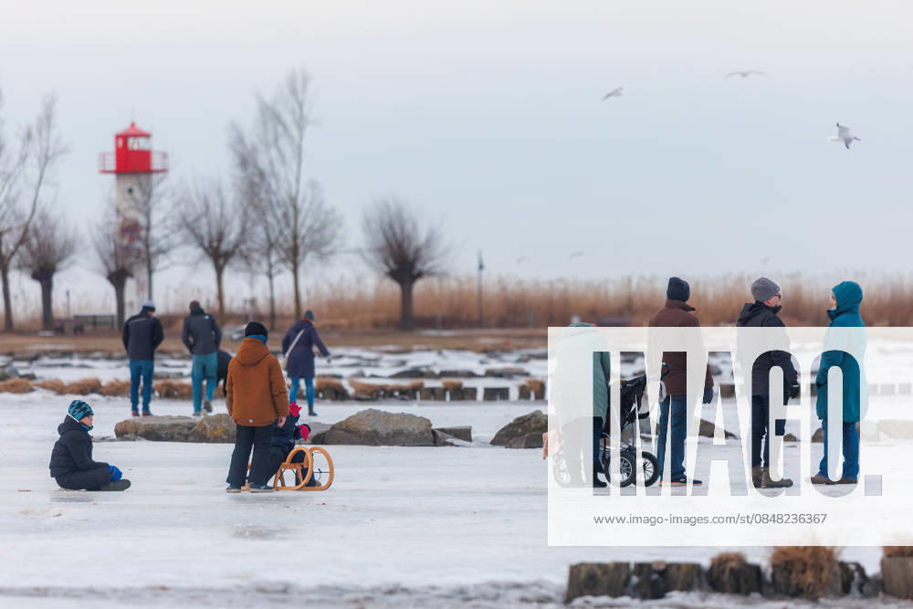The Szczecin Lagoon is completely frozen over in the seaside resort of Ueckermünde Children having fun on the ice with sledges Seaside resort of Ueckermünde Mecklenburg-Vorpommern Germany