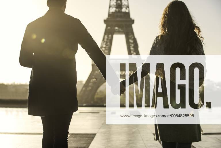 Couple walking towards Eiffel Tower