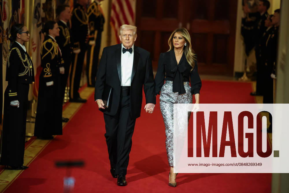 U.S. President Donald Trump and First Lady Melania Trump walk down the Cross Hall as they arrive for the Governors Dinner in the East Room of the White House on Saturday, February 21, 2026 in Washington, DC. WAX20260221230 SamuelxCorum