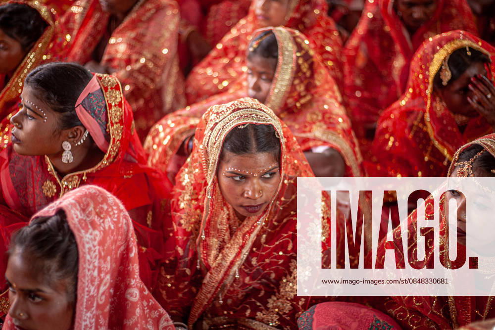 121 Couples Participate in Community-Funded Mass Wedding in Jharkhand, India - 22 Feb 2026 Brides dressed in traditional wedding attire wait for the start of a community-funded mass ceremony involving 121 couples. A community-funded mass wedding of 121 couples highlights the increasing reliance on collective ceremonies to bypass the prohibitive costs of traditional Indian marriages. These grassroots events offer a vital socio-economic lifeline, pooling local resources to provide financial relief for underprivileged families amid rising inflation. Gumla India