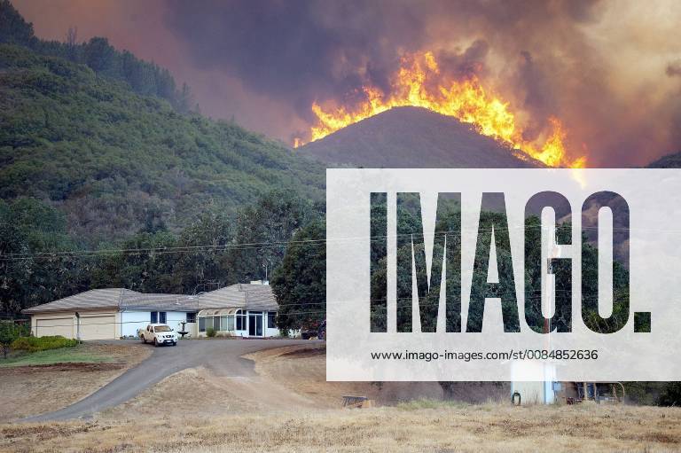 Lakeport, California, US - The River Fire backs down a hill towards a house just west of Scott s Valley Road near Lakeport in Lake County California on Thursday..According to Cal Fire as of this evening the Mendocino Complex Fire, comprised of the Ranch and River Fires, has burned 125,168 cares and is at 39% containment. There 3,232 personnel working the blaze and there 15,322 persons currently evacuated. Lakeport US - ZUMAmk2_ 20180802_zap_mk2_007
