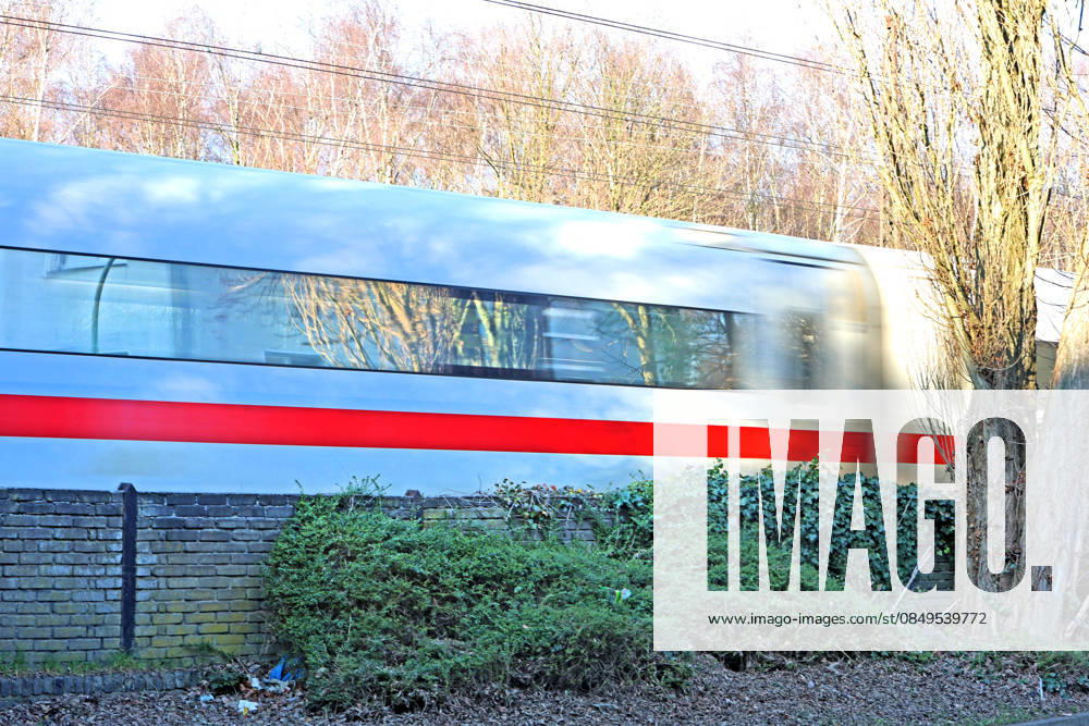 Long-distance traffic next to roads An ICE is traveling at a speed of 160 km h on a line in the Ruhr area next to a wall parallel to a road in the Dellwig district of Essen Essen North Rhine-Westphalia Germany Dellwig