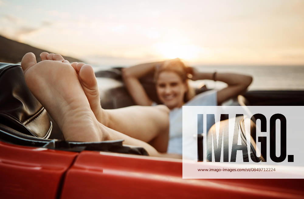 Road trip, rest or feet in car with beach sunset, outdoor destination or relaxing on tourist vacation. Travel, chill or woman at ocean with vehicle, weekend break or summer evening in Australia model released property released