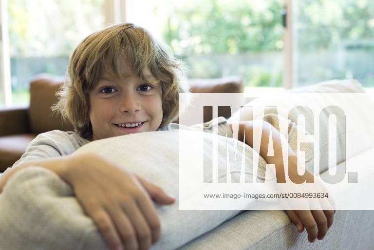Boy leaning on sofa