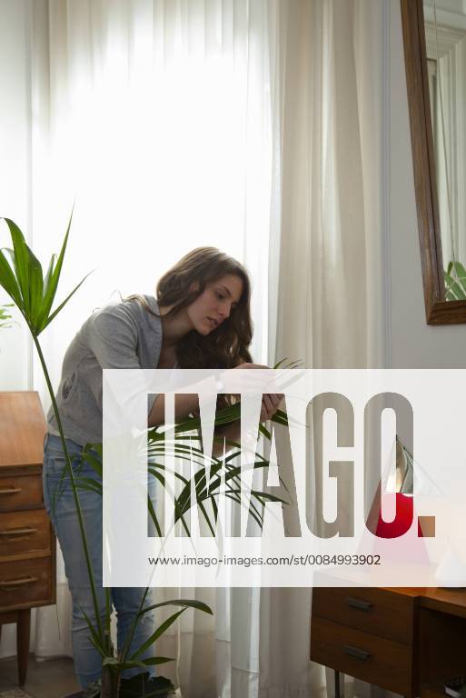 Woman caring for house plant