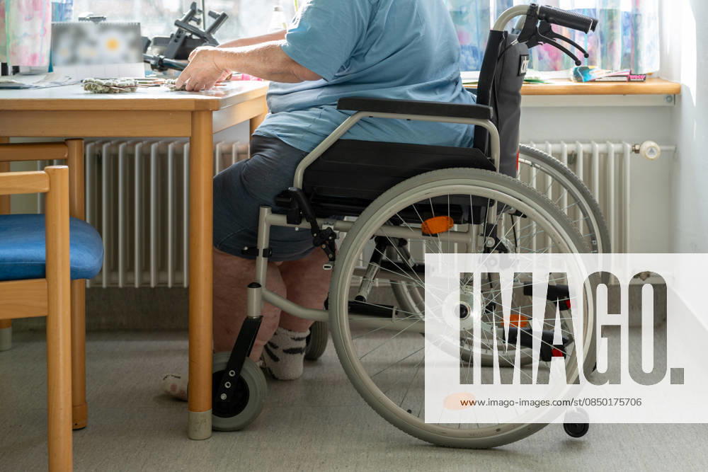 An elderly person in a wheelchair at a table highlights the challenges of everyday care. The image addresses inclusion, accessibility, and the support needed to live with dignity.