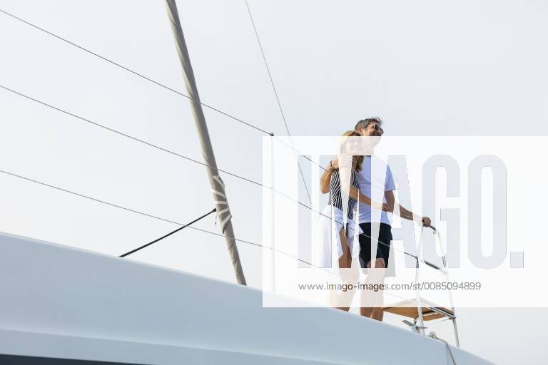 Mature couple making holidays, sailing on a catamaran model released Symbolfoto property released EBSF02669