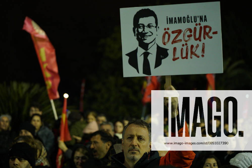 A person holds a placard reading Freedom for Imamoglu outside the Istanbul Metropolitan Municipality building during a rally to protest the first anniversary of the arrest of Istanbul Mayor Ekrem Imamoglu, the mayor of Istanbul in Istanbul, Turkey on March 18, 2026. Fatih Turkey - ZUMAu194 20260318_zip_u194_021