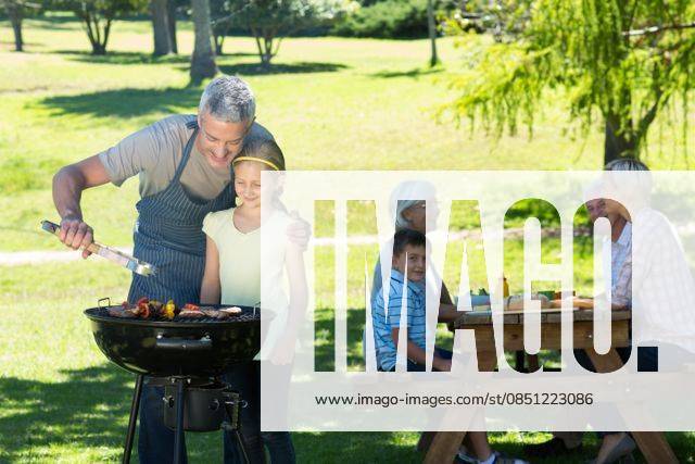 Happy father doing barbecue with his daughter Happy father doing barbecue with his daughter on a sunny day, model released, Cape Town, South Africa, 17.11.2014, 451932.jpg, park, countryside, nature, sunny, sunshine, summer, spring, lifestyle, leisure, fair hair, blonde, light hair, short hair, relaxing, content, happy, smiling, cheerful, love, affection, family, together, cute, childhood, family with two children, two parents, mother, father, daughter, son, grandparent, multi-generation family, recreational pursuit, weekend activities, barbecue, al fresco, lunch, meal, picnic table, helping, teaching, showing, learning 20s, Young Adult, Woman, Female, Caucasian, Child, Girl, 30s, Mid Adult, Man, Male, 60s, Senior, Elderly, Boy, 25-29 Yea