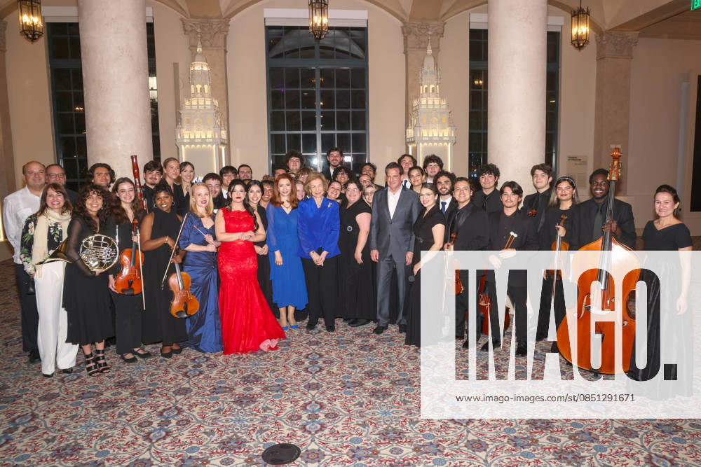 Queen Sofia of Spain (C) and the Consul General of Spain in Miami, Belen Alfaro Hernandez (C-L), pose with members of the Florida International University (FIU) orchestra and the Nicole Wertheim School of Musicduring the event Florida, Cuba and the Caribbean in the American Revolution at the Freedom Tower in Miami, Florida, USA, 20 March 2026. Queen Sofia of Spain inaugurated America&Spain250 in Miami, an academic initiative commemorating the 250th anniversary of the founding of the United States and highlighting Spain s contributions to the American Revolution and the shared history between the two countries, as part of her three-day visit to Florida. Queen Sofia inaugurates America&Spain250 in Miami to celebrate the 250th anniversa