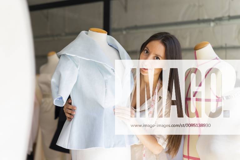 Young fashion designer fitting clothes on dressmaker s model model released Symbolfoto property released AFVF00764