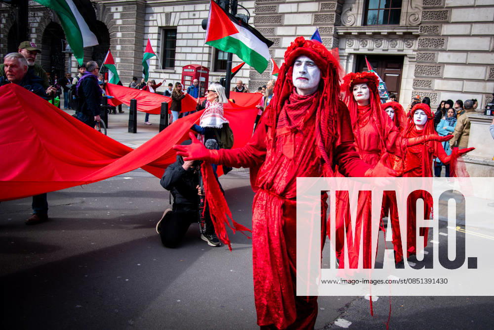 Pilgrimage for Palestine in London, UK - 22 Mar 2026 Protesters dressed in red costumes walk with Palestinian flags and a large banner during the Pilgrimage for Palestine 2026 at Parliament Square. Pilgrimage4Palestine originated in 2025. In an extraordinary show of empathy and resistance, Peter Oswald, South West poet and playwright, walked 150 miles from Bristol to London Parliament Square while fasting for Ramadan. London United Kingdom