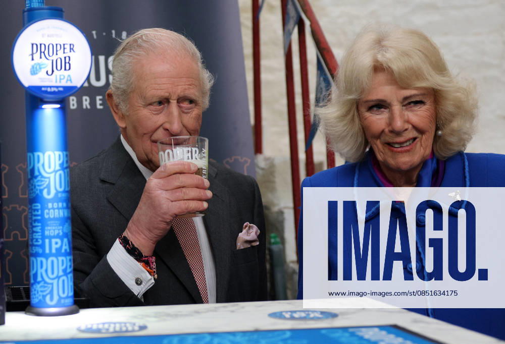 King Charles and Queen Camilla visit Cornwall, UK, 24 March 2026 Britain s Queen Camilla reacts as she stands with Britain s King Charles III, as he tastes a pint of St Austell Brewery s Proper Job IPA 0.5% that he pulled, during a visit to the The Market Hall in St Austell, south-west England on March 24, 2026., Credit:ADRIAN DENNIS Avalon United Kingdom, Cornwall