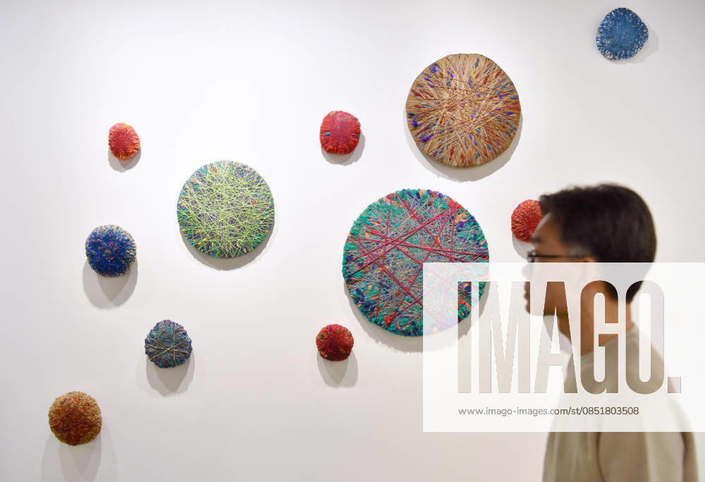 (260326) -- HONG KONG, March 26, 2026 -- A visitor views exhibits at the preview of Art Basel Hong Kong 2026 at the Hong Kong Convention and Exhibition Center in south China s Hong Kong, March 25, 2026. Art Basel Hong Kong 2026 held its preview here on Wednesday, bringing together 240 galleries from 41 countries and regions. Featuring six themed sectors and programs, the fair will open to the public from Friday to Sunday. ) CHINA-HONG KONG-ART BASEL-PREVIEW (CN) ChenxDuo