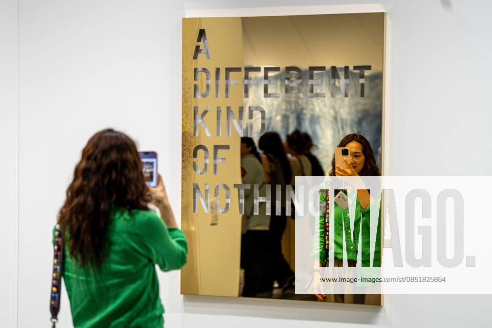 HONGKONG-ART ART-BASEL A woman taking a photo of an art display on the wall at Art Basel 2026 in Hong Kong, March 26, 2026. NEXPHER Vernon Yuen HONG KONG