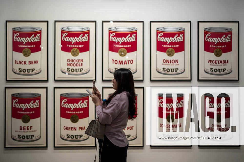 HONGKONG-ART ART-BASEL A woman taking a photo with her phone in front of Campbell s Soup Cans drawings at Art Basel 2026 in Hong Kong, March 26, 2026. NEXPHER Vernon Yuen HONG KONG