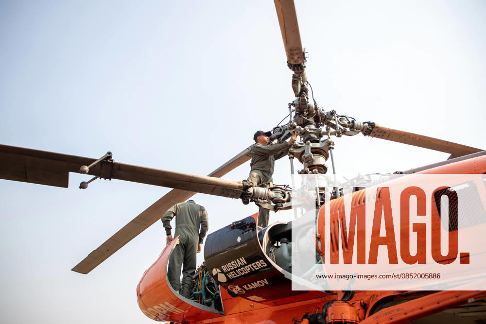 A KA-32 helicopter from the Department of Disaster Prevention and Mitigation is prepared for aerial firefighting operations in Chiang Mai, northern Thailand, as crew members carry out checks and equipment setup while authorities respond to ongoing wildfires and rising PM2.5 air pollution. Chiang Mai Thailand - ZUMAs197 20260327_aaa_s197_318