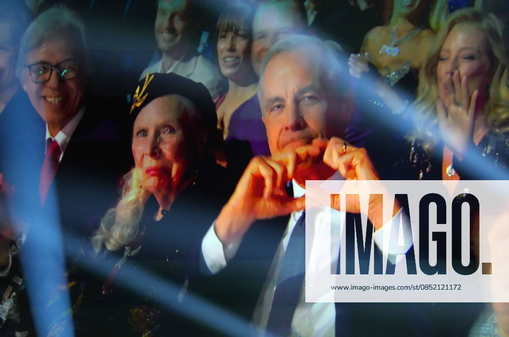 Prime Minister Mark Carney sits with Joni Mitchell in a photo of a live video screen at the 2026 Juno Awards in Hamilton, on Sunday, March 29, 2026. Hamilton CANADA - ZUMAc35_ 20260329_zaf_c35_215