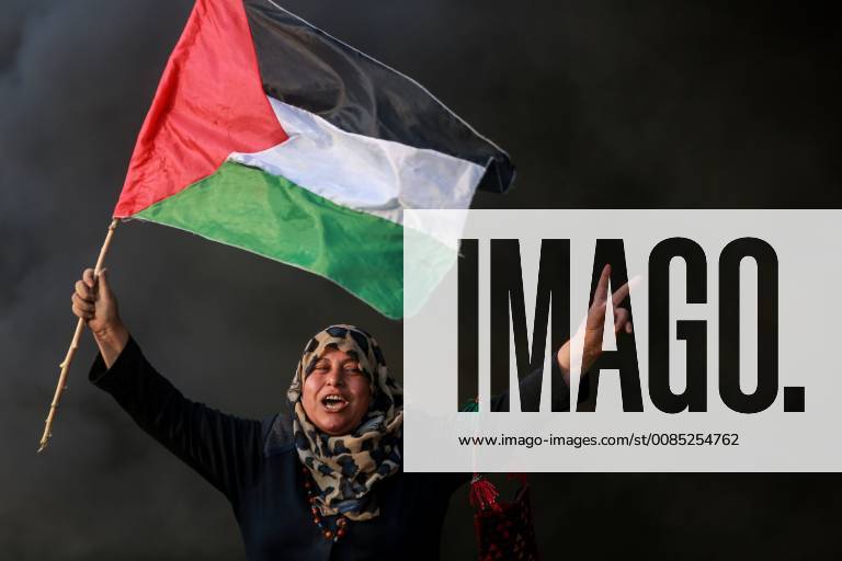 (180831) -- GAZA, Aug. 31, 2018 () -- A Palestinian woman holds a national flag as she takes part in clashes with Israeli troops on the Gaza-Israel border, east of Gaza City, on Aug. 31, 2018. Around 180 Palestinians were injured on Friday during clashes with Israeli soldiers on the borders between the eastern Gaza Strip and Israel, the Gaza health ministry said. () MIDEAST-GAZA-CLASHES Xinhua