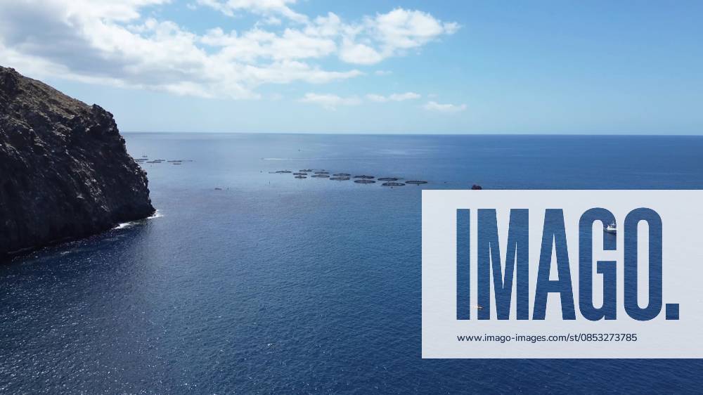 Coastline of Atlantic Ocean with Fish farms and a Boat to a sunny Day 1127164958