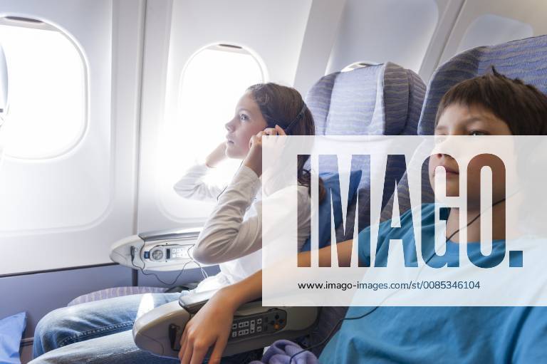 Children watching movie on airplane with headphones