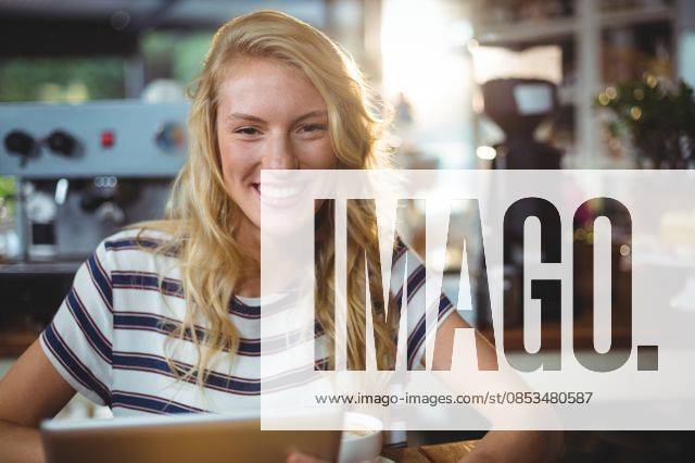 Woman sitting in a cafe using digital tablet Portrait of woman sitting in a cafe using digital tablet, model released, , property released, Cape Town, South Africa, 30.05.2016, 797483.jpg, table, cafe, coffee shop, cafeteria, restaurant, hotel, casual clothing, sitting, holding, smiling, cheerful, web, internet, touching, reading, scrolling, digital tablet, tablet computer, tablet pc, touchscreen, wireless technology, communication, connection, happy, lifestyle, leisure, pretty, attractive Indoors,Portrait,Looking at camera,Day