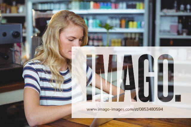 Woman sitting in a cafe using digital tablet Thoughtful woman sitting in a cafe using digital tablet, model released, , property released, Cape Town, South Africa, 30.05.2016, 797484.jpg, table, cafe, coffee shop, cafeteria, restaurant, hotel, casual clothing, sitting, holding, serious, thoughtful, web, internet, touching, reading, scrolling, digital tablet, tablet computer, tablet pc, touchscreen, wireless technology, communication, connection, lifestyle, leisure, pretty, attractive Indoors
